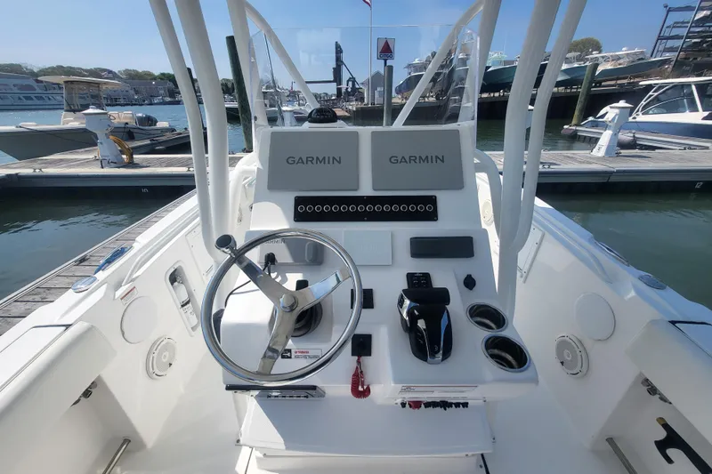 Slide: The Image of Edgewater 245CC 2022 boat dashboard with Garmin navigation at marina dock. - 43