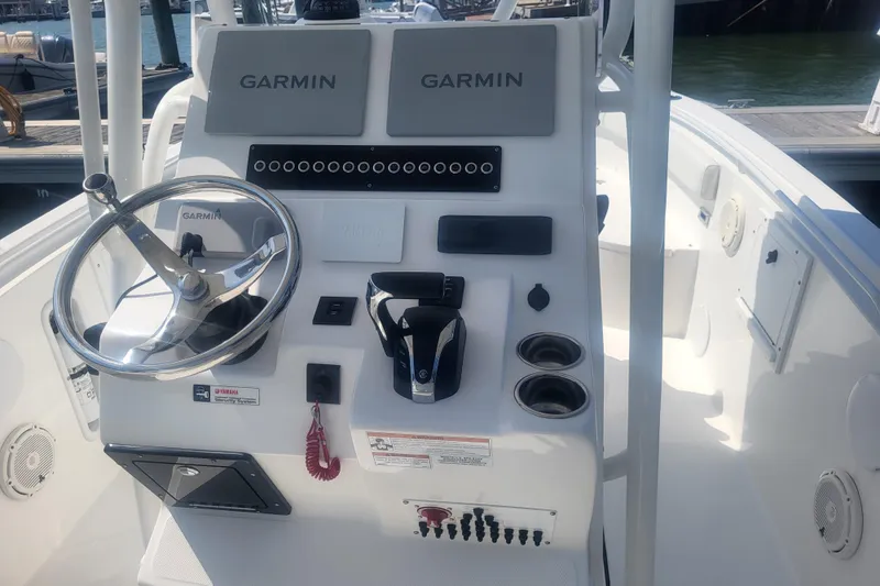 Slide: The Image of Edgewater 245CC 2022 boat console with Garmin displays and steering wheel. - 44