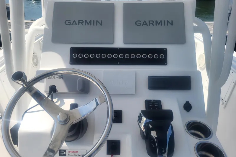 Slide: The Image of Edgewater 245CC 2022 boat dashboard with Garmin displays and Yamaha controls. - 45