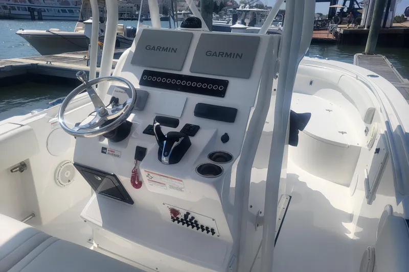 Slide: The Image of 2022 Edgewater 245CC boat cockpit with Garmin navigation system at marina. - 46