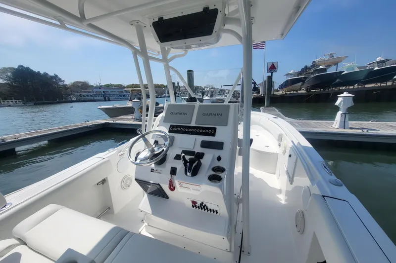 Slide: The Image of Edgewater 245CC 2022 boat at dock with Garmin controls. - 49