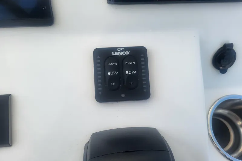 Slide: The Image of Lenco trim tab control panel on 2022 Edgewater 245CC boat dashboard. - 52