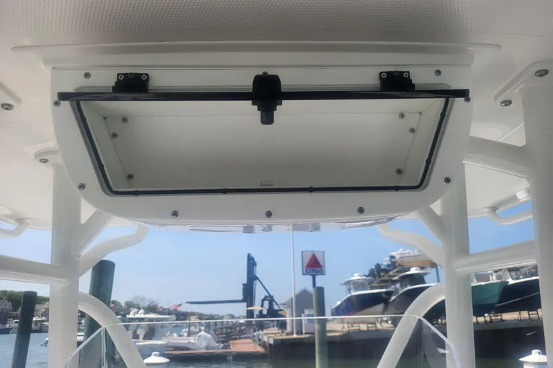 Slide: The Image of 2022 Edgewater 245CC boat storage compartment with marina background. - 53