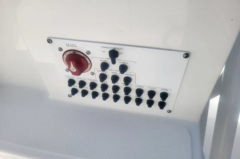 Slide: The Image of Control panel of 2022 Edgewater 245CC boat with switches and main power dial. - 59