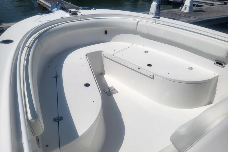 Slide: The Image of 2022 Edgewater 245CC boat interior with spacious seating and storage. - 6