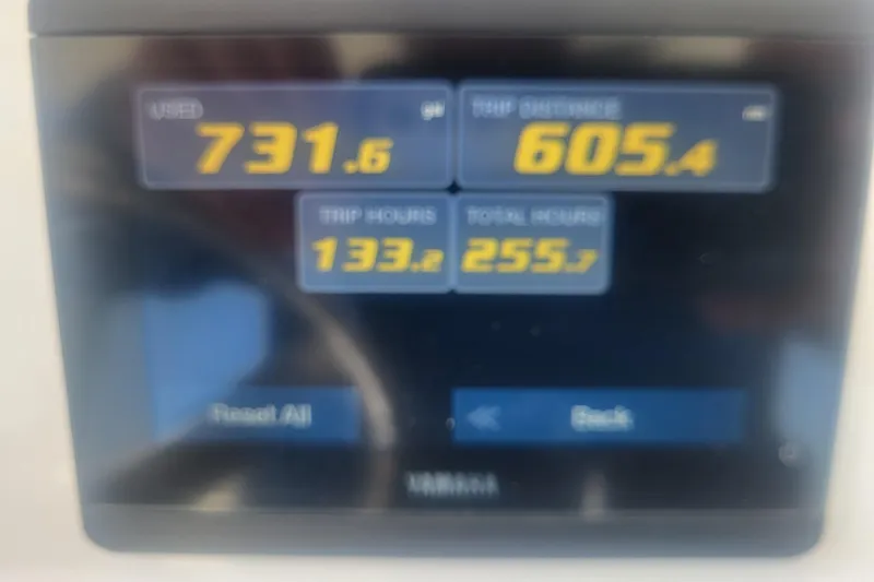Slide: The Image of Digital display showing fuel usage, trip distance, and hours for 2022 Edgewater 245CC boat. - 62