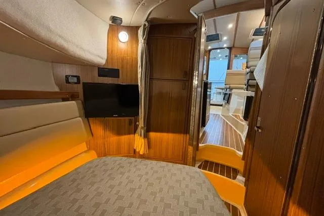 Slide: The Image of Interior of 2025 Ranger Tugs R-31 CB, featuring cozy seating and modern wood finishes. - 16