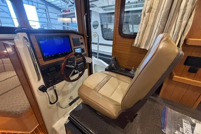 Slide: The Image of Interior helm of 2025 Ranger Tugs R-31 CB with modern navigation system and comfortable seating. - 18