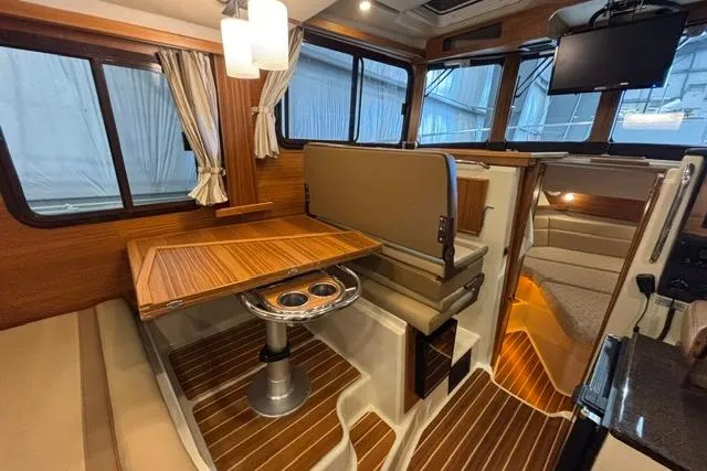 Slide: The Image of Interior of 2025 Ranger Tugs R-31 CB, featuring elegant wood finishes and modern amenities. - 20