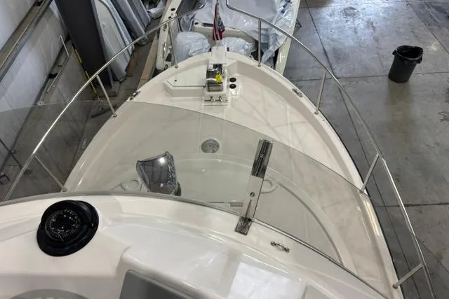 Slide: The Image of 2025 Ranger Tugs R-31 CB boat bow view in a warehouse setting. - 4