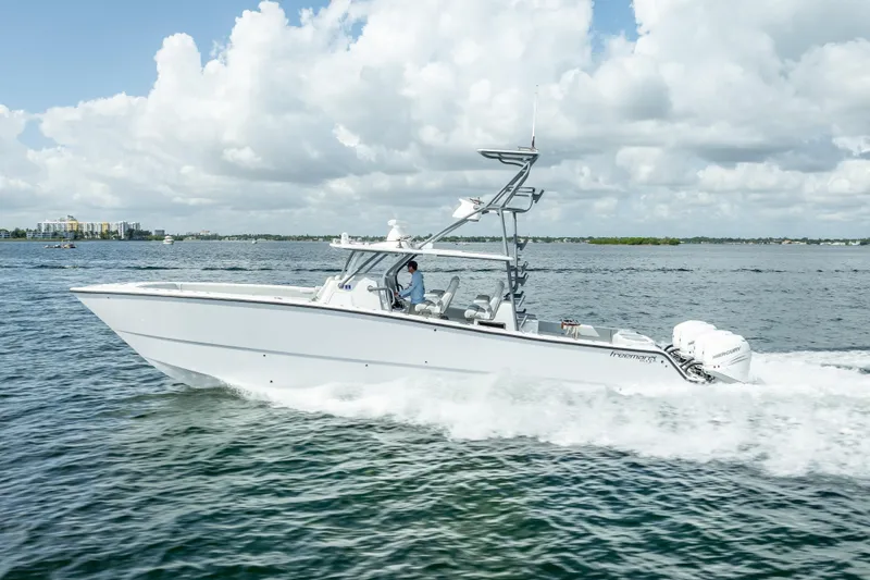 The Image of 2020 Freeman 42LR boat cruising on open water under a cloudy sky. - 1
