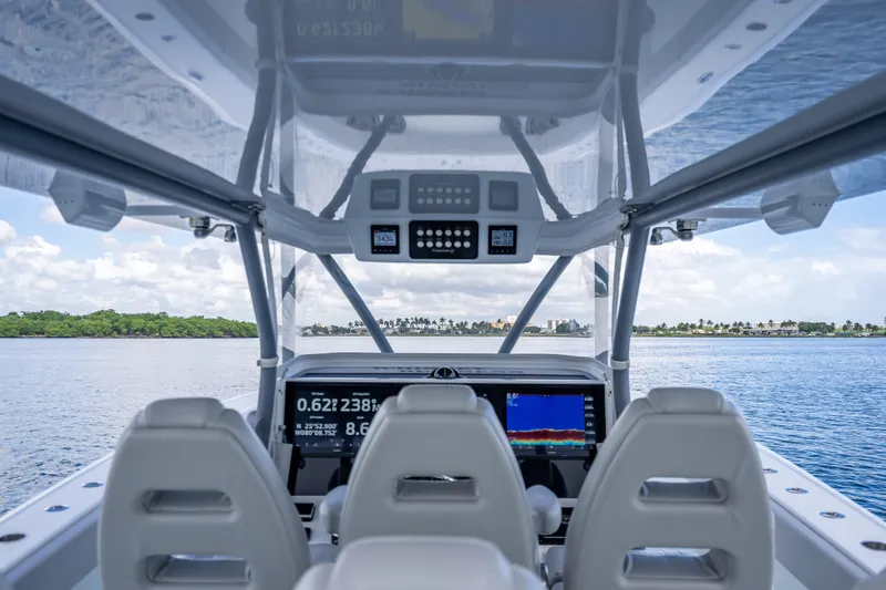 Slide: The Image of Interior view of 2020 Freeman 42LR boat cockpit with navigation screens and ocean scenery. - 14