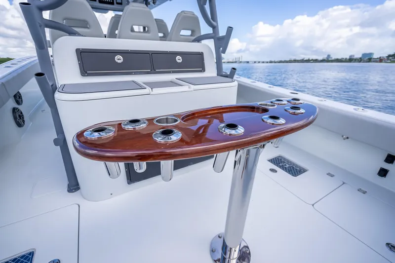 Slide: The Image of 2020 Freeman 42LR boat interior with rod holders and seating, overlooking calm waters. - 15