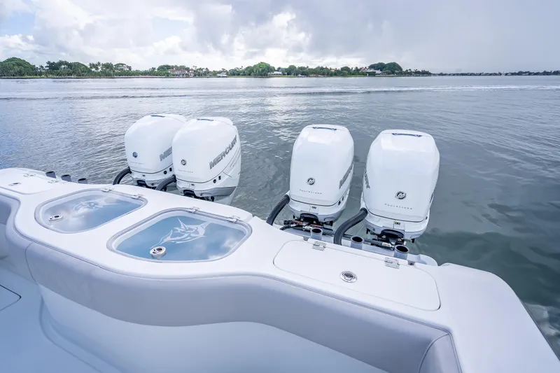 Slide: The Image of Four Mercury outboard engines on a 2020 Freeman 42LR boat, with a scenic water backdrop. - 18