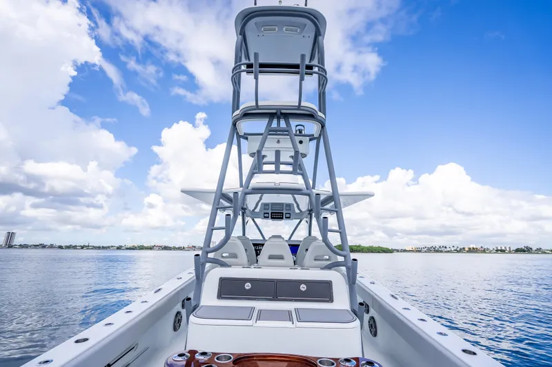 Slide: The Image of 2020 Freeman 42LR boat on calm water under a clear blue sky. - 26