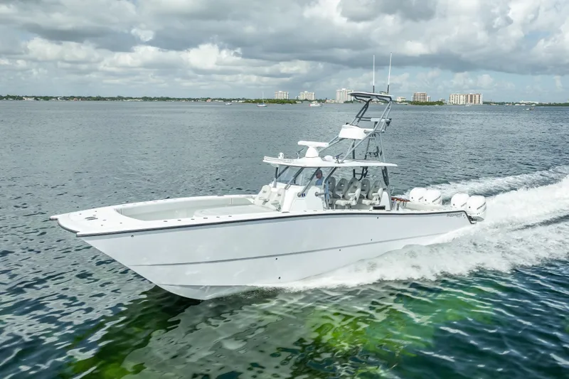 Slide: The Image of 2020 Freeman 42LR boat cruising on open water under cloudy skies. - 3