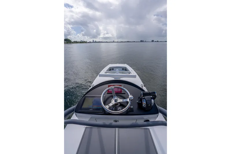 Slide: The Image of Cockpit view of 2020 Freeman 42LR boat on calm water under cloudy sky. - 35