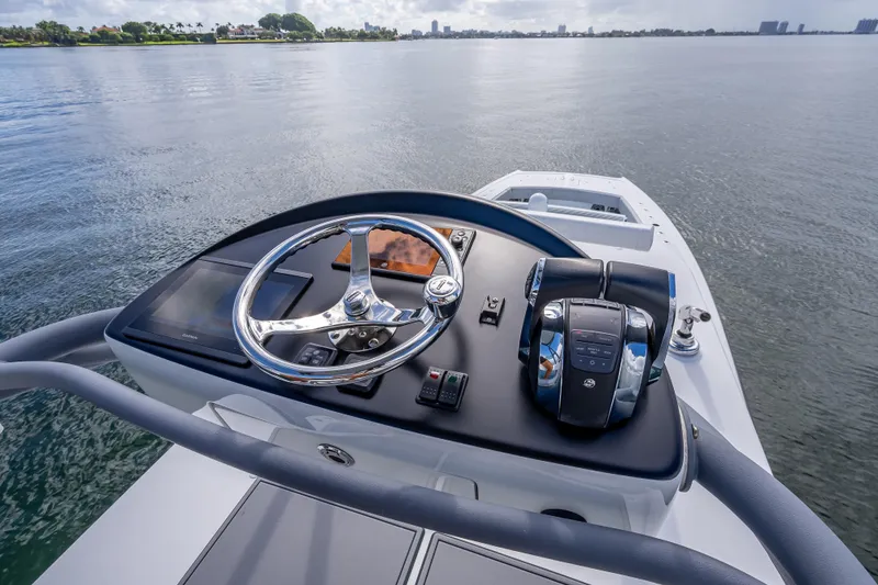 Slide: The Image of Helm of 2020 Freeman 42LR boat with steering wheel and controls on calm water. - 37