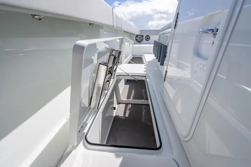 Slide: The Image of 2020 Freeman 42LR boat interior with storage compartments and rod holders. - 38