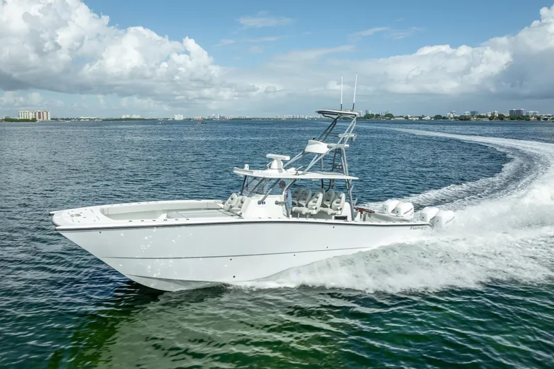 Slide: The Image of 2020 Freeman 42LR boat cruising on open water under a clear sky. - 4