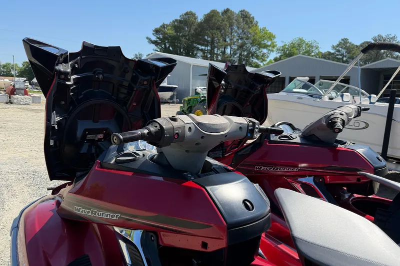 Slide: The Image of 2013 Yamaha WaveRunner FX HO jet skis parked outdoors, with open storage compartments. - 11