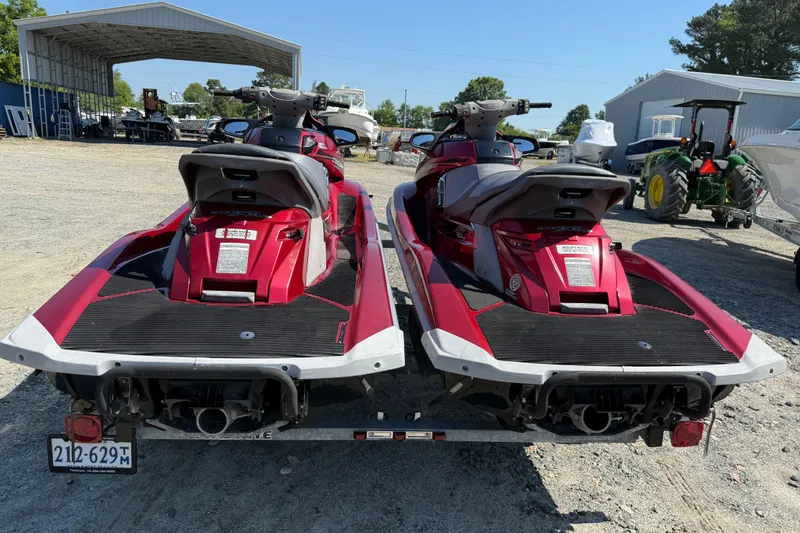 Slide: The Image of Two red 2013 Yamaha WaveRunner FX HO jet skis on a trailer in a yard. - 4
