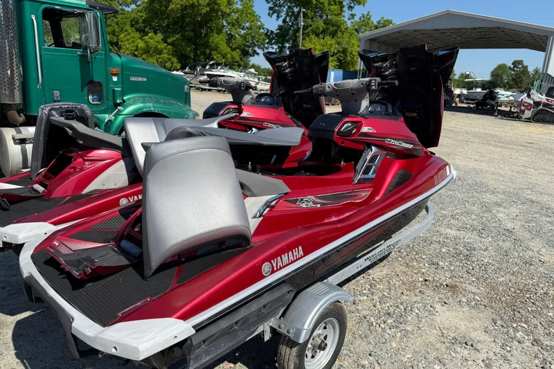 Slide: The Image of 2013 Yamaha WaveRunner FX HO jet skis on a trailer, parked outdoors. - 6