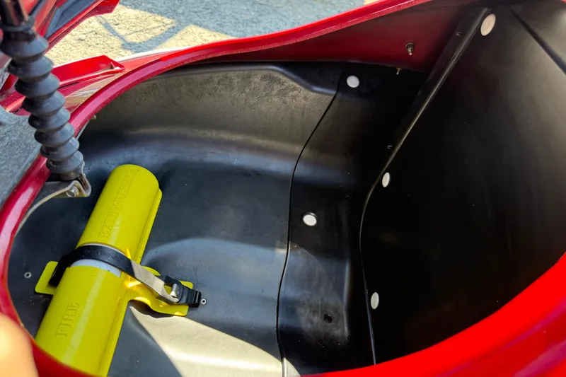 Slide: The Image of Storage compartment of a 2013 Yamaha WaveRunner FX HO with a yellow fire extinguisher. - 8
