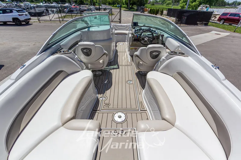 Slide: The Image of 2008 Crownline 240 LS boat interior with beige seating and steering wheel. - 12