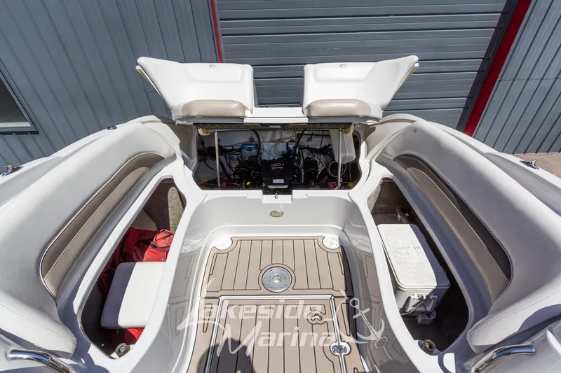 Slide: The Image of 2008 Crownline 240 LS boat interior with open engine compartment and seating area. - 15