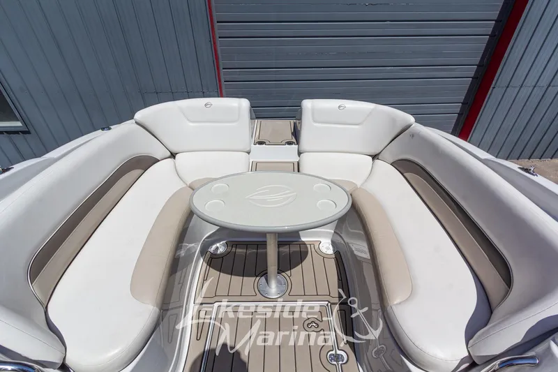 Slide: The Image of 2008 Crownline 240 LS boat interior with white seating and round table. - 17