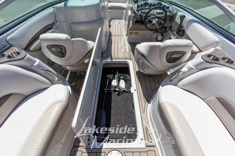 Slide: The Image of 2008 Crownline 240 LS boat interior with open storage compartment and luxurious seating. - 18