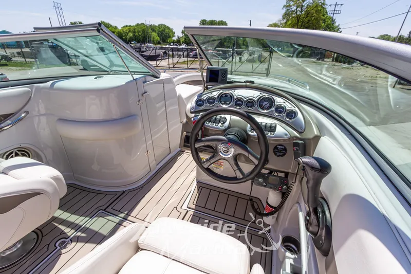 Slide: The Image of Interior view of a 2008 Crownline 240 LS boat cockpit with steering wheel and controls. - 19