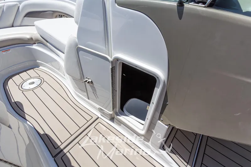 Slide: The Image of 2008 Crownline 240 LS boat interior with open storage compartment and cushioned seating. - 28