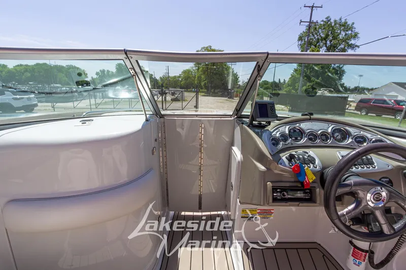 Slide: The Image of 2008 Crownline 240 LS boat cockpit with steering wheel and dashboard controls. - 29