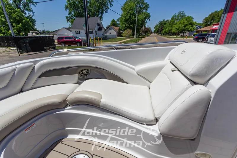 Slide: The Image of 2008 Crownline 240 LS boat interior with white leather seating, parked near Lakeside Marina. - 33
