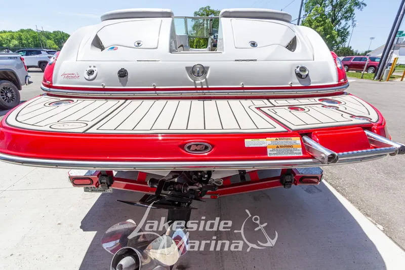 Slide: The Image of Rear view of a 2008 Crownline 240 LS boat with red trim at Lakeside Marina. - 5