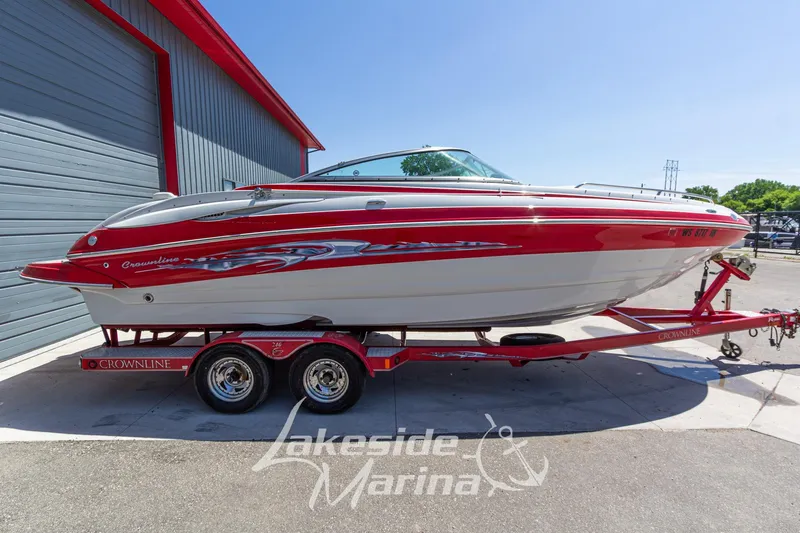 Slide: The Image of 2008 Crownline 240 LS boat on trailer at Lakeside Marina, featuring red and white design. - 8