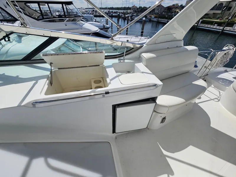 Slide: The Image of 1999 Carver 530 Voyager Pilothouse with seating area and storage. - 10
