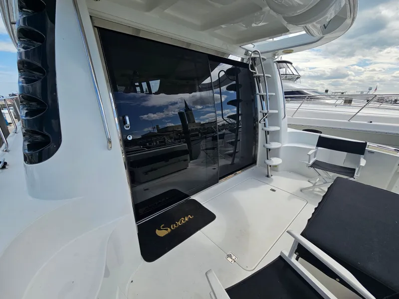 Slide: The Image of 1999 Carver 530 Voyager Pilothouse yacht deck with chairs and ladder. - 13