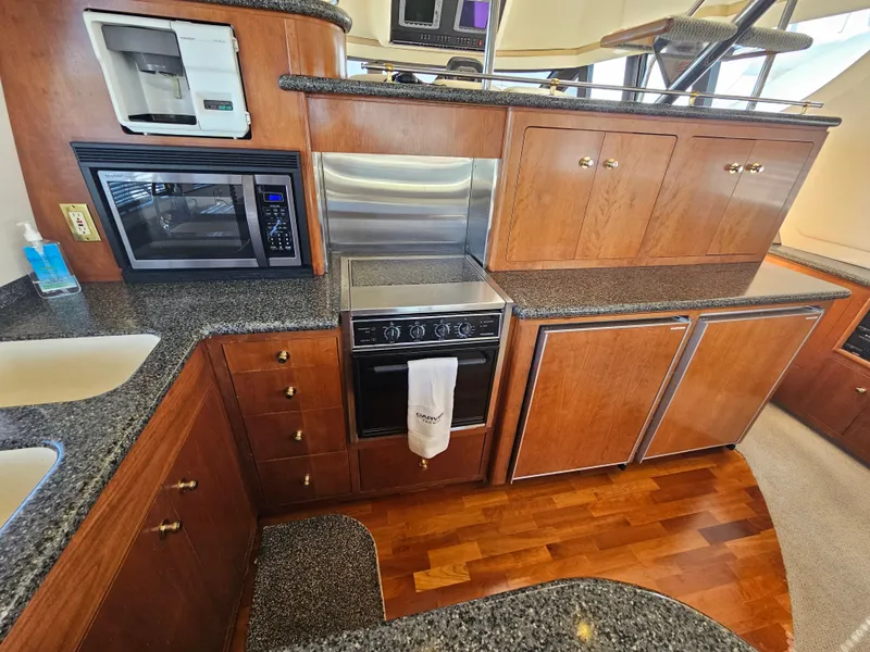 Slide: The Image of 1999 Carver 530 Voyager Pilothouse kitchen with wooden cabinets. - 20