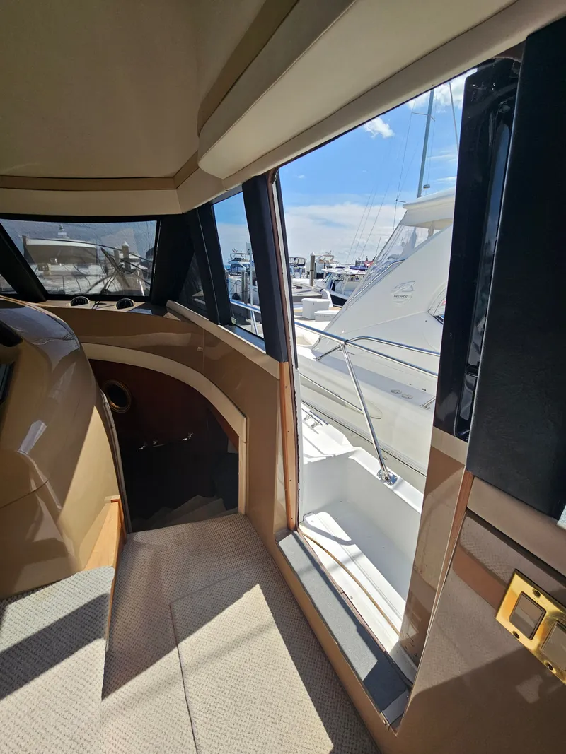 Slide: The Image of Interior of 1999 Carver 530 Voyager Pilothouse, view of marina. - 23