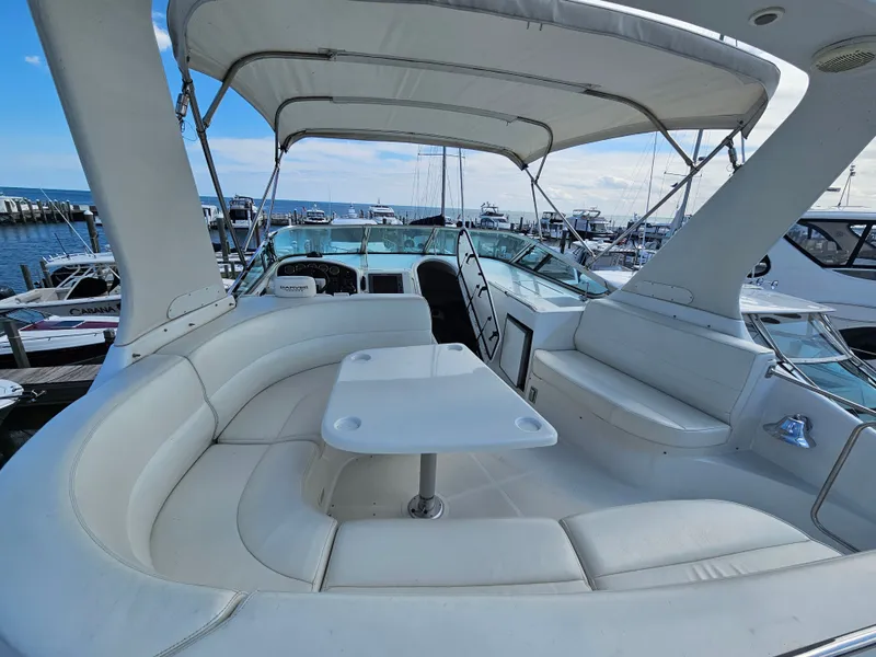Slide: The Image of 1999 Carver 530 Voyager Pilothouse with spacious deck area in harbor. - 7