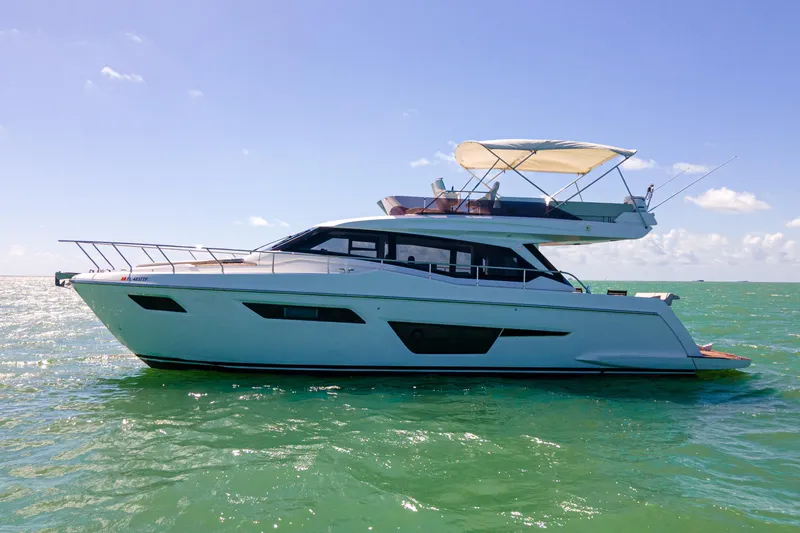 Slide: The Image of 2022 Ferretti Yachts 500 cruising on calm ocean waters under clear blue skies. - 14
