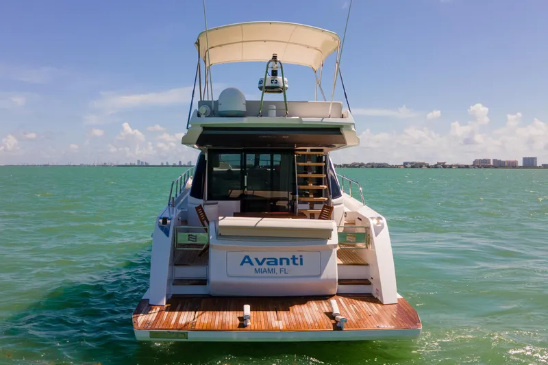Slide: The Image of 2022 Ferretti Yachts 500 on water, rear view, sunny day, Miami skyline. - 16