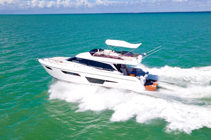 Slide: The Image of 2022 Ferretti Yachts 500 cruising on turquoise waters under a clear sky. - 3
