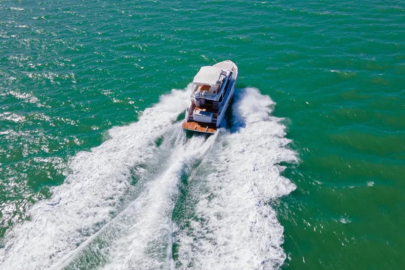 Slide: The Image of 2022 Ferretti Yachts 500 cruising on open sea, creating dynamic water trails. - 4