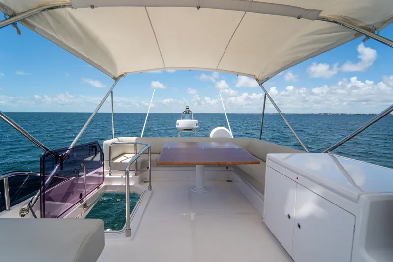 Slide: The Image of Flybridge of 2022 Ferretti Yachts 500 with ocean view and seating area. - 46