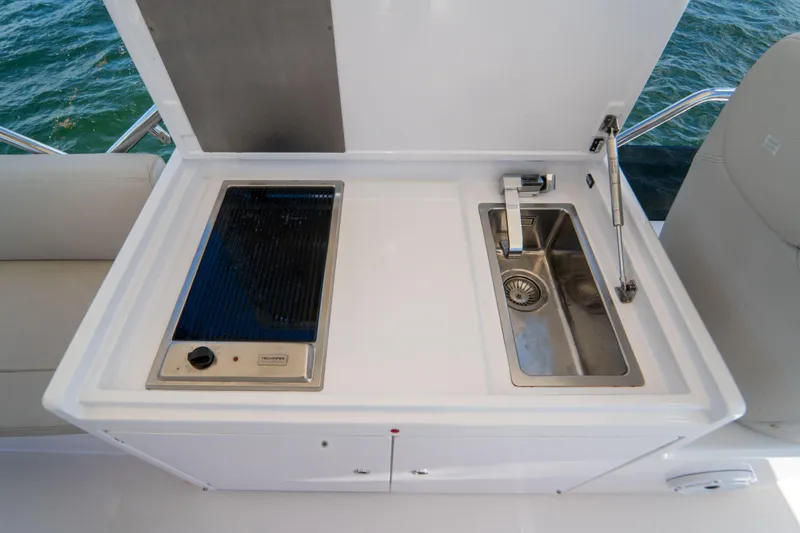 Slide: The Image of Outdoor kitchenette on 2022 Ferretti Yachts 500, featuring a grill and sink. - 48