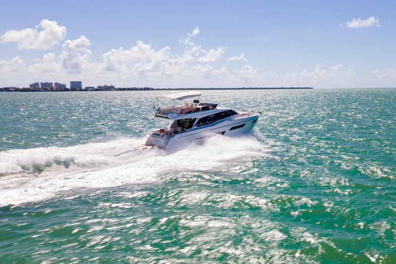 Slide: The Image of 2022 Ferretti Yachts 500 cruising on open sea under clear blue sky. - 7